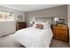 Comfortable main bedroom with a queen-size bed and natural light at 6141 S Estes St, Littleton, CO 80123