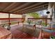 Cozy covered patio with stylish seating, a wooden deck, and a view of the backyard at 6141 S Estes St, Littleton, CO 80123