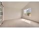 Bright bedroom with neutral carpeting, a large window, and a sliding barn door at 15870 Duckweed Ct, Parker, CO 80134