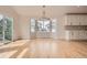 Bright dining area with hardwood floors, stylish chandelier, and large windows for natural light at 15870 Duckweed Ct, Parker, CO 80134