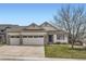 Charming single-Gathering home with a three-car garage, manicured lawn, and inviting curb appeal at 15870 Duckweed Ct, Parker, CO 80134