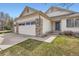 Inviting single-Gathering home featuring a three-car garage and a well-maintained front lawn at 15870 Duckweed Ct, Parker, CO 80134