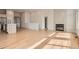 Spacious living area featuring hardwood floors, a fireplace, open kitchen and lots of natural light at 15870 Duckweed Ct, Parker, CO 80134