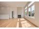 Bright living room with hardwood floors, a modern fireplace, and large windows at 15870 Duckweed Ct, Parker, CO 80134