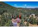Overhead shot showcases the house nestled within the lush greenery, offering a tranquil, secluded atmosphere at 8171 S Homesteader Dr, Morrison, CO 80465