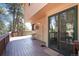 Spacious back deck features outdoor seating area with views of towering pine trees at 8171 S Homesteader Dr, Morrison, CO 80465