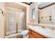 Bathroom showcasing a glass enclosed shower, light stone countertop, and decorative western themed wallpaper border at 8171 S Homesteader Dr, Morrison, CO 80465