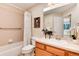 Bathroom features a tiled shower, vanity with sink, and charming decor at 8171 S Homesteader Dr, Morrison, CO 80465