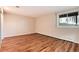 Basement bedroom with wood-look flooring, large window, and neutral walls, offers a versatile living space at 8171 S Homesteader Dr, Morrison, CO 80465