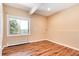 Bedroom with hardwood floors, view to the outdoors, and light walls at 8171 S Homesteader Dr, Morrison, CO 80465