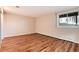 Bedroom with hardwood floors, large windows, and views of the forest at 8171 S Homesteader Dr, Morrison, CO 80465