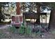 This image features a chicken coop with fenced enclosure surrounded by lush trees and greenery at 8171 S Homesteader Dr, Morrison, CO 80465