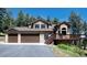 Charming two-story home featuring a three-car garage, stone accents and a welcoming porch at 8171 S Homesteader Dr, Morrison, CO 80465