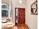 Lovely home entryway with a beautiful door, light-filled windows, and wood floors at 8171 S Homesteader Dr, Morrison, CO 80465