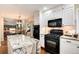 Well-equipped kitchen with an island, granite counters, modern appliances, and ample cabinet space at 8171 S Homesteader Dr, Morrison, CO 80465