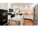 Modern kitchen with granite countertops, white cabinets, and stainless steel appliances at 8171 S Homesteader Dr, Morrison, CO 80465
