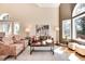 An airy living room boasting ample natural light, plush seating, and elegant decor at 8171 S Homesteader Dr, Morrison, CO 80465