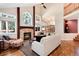 Inviting living room featuring a stone fireplace, vaulted ceiling, and large windows with beautiful outdoor views at 8171 S Homesteader Dr, Morrison, CO 80465