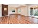 Bright living room featuring hardwood floors, multiple windows, and sliding door to the outside deck at 8171 S Homesteader Dr, Morrison, CO 80465