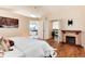 Comfortable bedroom with hardwood floors, a decorative fireplace, and an ensuite bath with soaking tub at 8171 S Homesteader Dr, Morrison, CO 80465