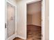 View into a wine cellar featuring a decorated door, leading to a room with hardwood floors and neutral walls at 8171 S Homesteader Dr, Morrison, CO 80465