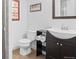 Bathroom featuring toilet and sink with dark cabinets and drawers at 7201 E Quincy Ave # 102, Denver, CO 80237