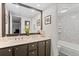 Bathroom featuring double vanity, large mirror and a shower with marble wall at 7201 E Quincy Ave # 102, Denver, CO 80237