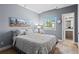 Cozy bedroom with a cityscape art piece, a bright window, and ensuite bathroom at 7201 E Quincy Ave # 102, Denver, CO 80237