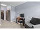 Comfortable bedroom with desk area, grey chair and neutral carpet at 7201 E Quincy Ave # 102, Denver, CO 80237