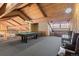 Upstairs game room features exposed wood rafters, a pool table, and seating at 7201 E Quincy Ave # 102, Denver, CO 80237