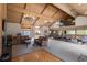 Spacious living room features soaring ceilings, exposed beams, and leather furniture at 7201 E Quincy Ave # 102, Denver, CO 80237