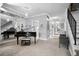 Open floor plan living room with a grand piano and neutral decor at 7201 E Quincy Ave # 102, Denver, CO 80237