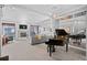 Spacious living room with a cozy fireplace, plush carpeting, and a grand piano reflecting luxury at 7201 E Quincy Ave # 102, Denver, CO 80237