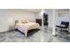 Basement bedroom with painted brick, polished concrete floors, and neutral-toned bedding at 3138 N Josephine St, Denver, CO 80205