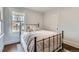 Cozy bedroom with a comfortable bed, decorative pillows, and a view of the neighborhood at 3138 N Josephine St, Denver, CO 80205