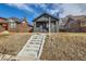 Charming painted brick bungalow with landscaped yard and inviting entryway steps at 3138 N Josephine St, Denver, CO 80205