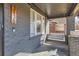 Welcoming covered front porch with decorative iron gate, painted brick, and swing at 3138 N Josephine St, Denver, CO 80205