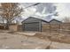 Gray detached garage with traditional sectional door and horizontal wood fencing on both sides at 3138 N Josephine St, Denver, CO 80205