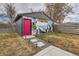 Detached garage with pink door and decorative mural in landscaped yard with stone walkway and solar lights at 3138 N Josephine St, Denver, CO 80205