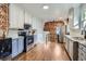Bright, open kitchen featuring stainless steel appliances and exposed brick details at 3138 N Josephine St, Denver, CO 80205