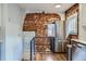 Kitchen area showcases exposed brick wall and modern stainless steel refrigerator at 3138 N Josephine St, Denver, CO 80205
