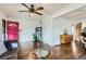 Stylish living room boasts hardwood floors, a vibrant pink door, and abundant natural light at 3138 N Josephine St, Denver, CO 80205