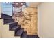 Stairway showcasing exposed brick, a painted staircase, and a contrasting white wall at 3138 N Josephine St, Denver, CO 80205