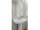 Bathroom features a pedestal sink with oval mirror at 19216 E Idaho Pl # 102, Aurora, CO 80017