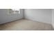 Bright bedroom with a window bringing in natural light and neutral colored walls and carpets at 19216 E Idaho Pl # 102, Aurora, CO 80017