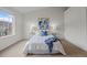 Spacious bedroom with large window, carpet floors, and stylish decor at 19216 E Idaho Pl # 102, Aurora, CO 80017