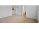 Bedroom with tan carpets and a view into the bathroom and a built in closet at 19216 E Idaho Pl # 102, Aurora, CO 80017