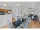 Bright dining area featuring modern table, kitchen, and hardwood floors at 19216 E Idaho Pl # 102, Aurora, CO 80017