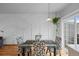 Modern dining room with a stylish glass table, patterned chairs, and elegant lighting at 19216 E Idaho Pl # 102, Aurora, CO 80017