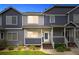 Charming townhome featuring a welcoming entrance with well-manicured landscaping at twilight at 19216 E Idaho Pl # 102, Aurora, CO 80017